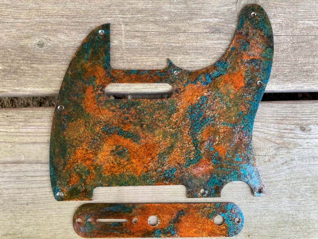 relic tele pickguard with blue and rusted orange hues