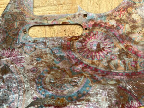 rusted pickguard with paisley pattern