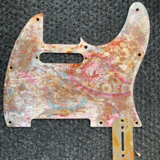 Rusted tele pickguard with paisley pattern embedded.Pink and blue colours, Gloss finish . Ships free